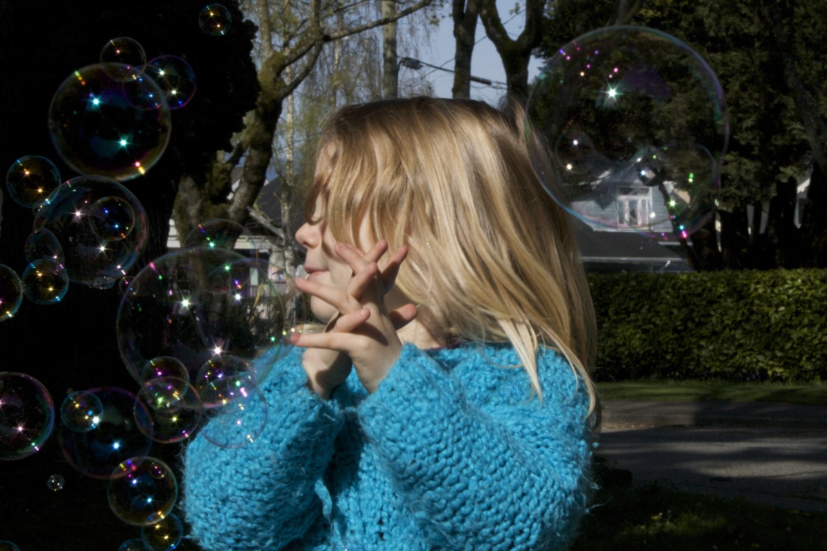 Girl catching bubbles