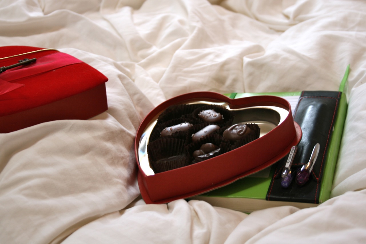 Chocolates in bed with notebook Chocolates in bed with notebook